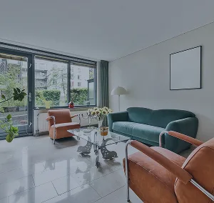 A modern living space with a large green couch and assorted furniture