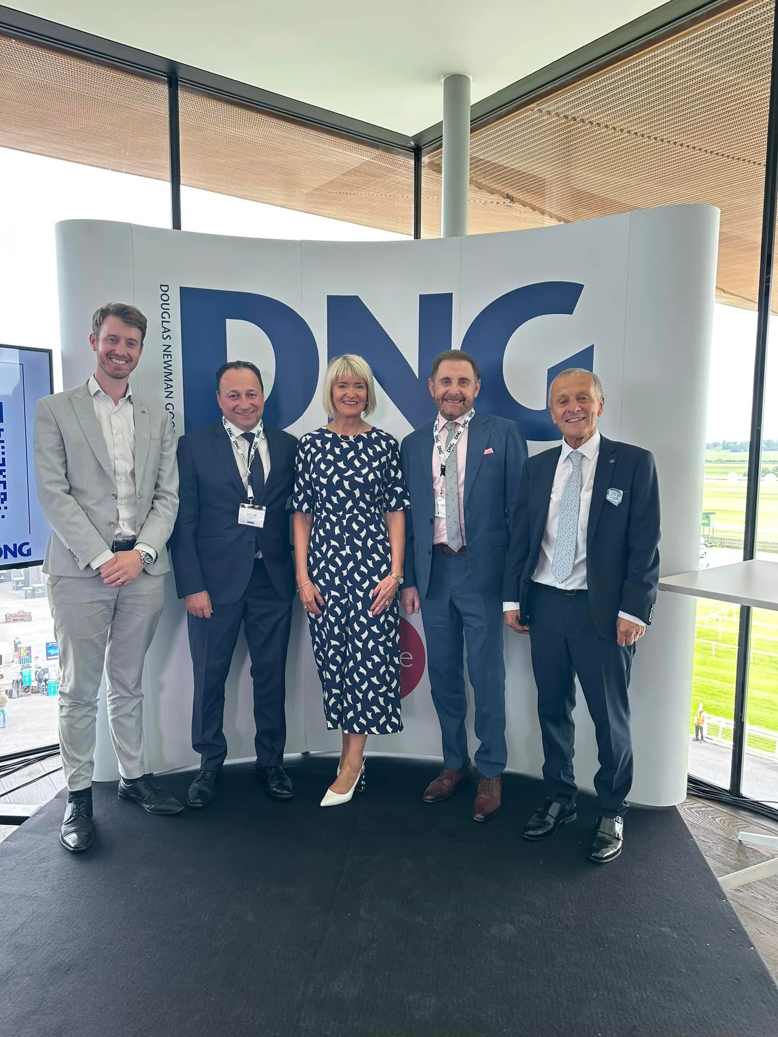 DNG Ella Dunphy team in front of DNG signage