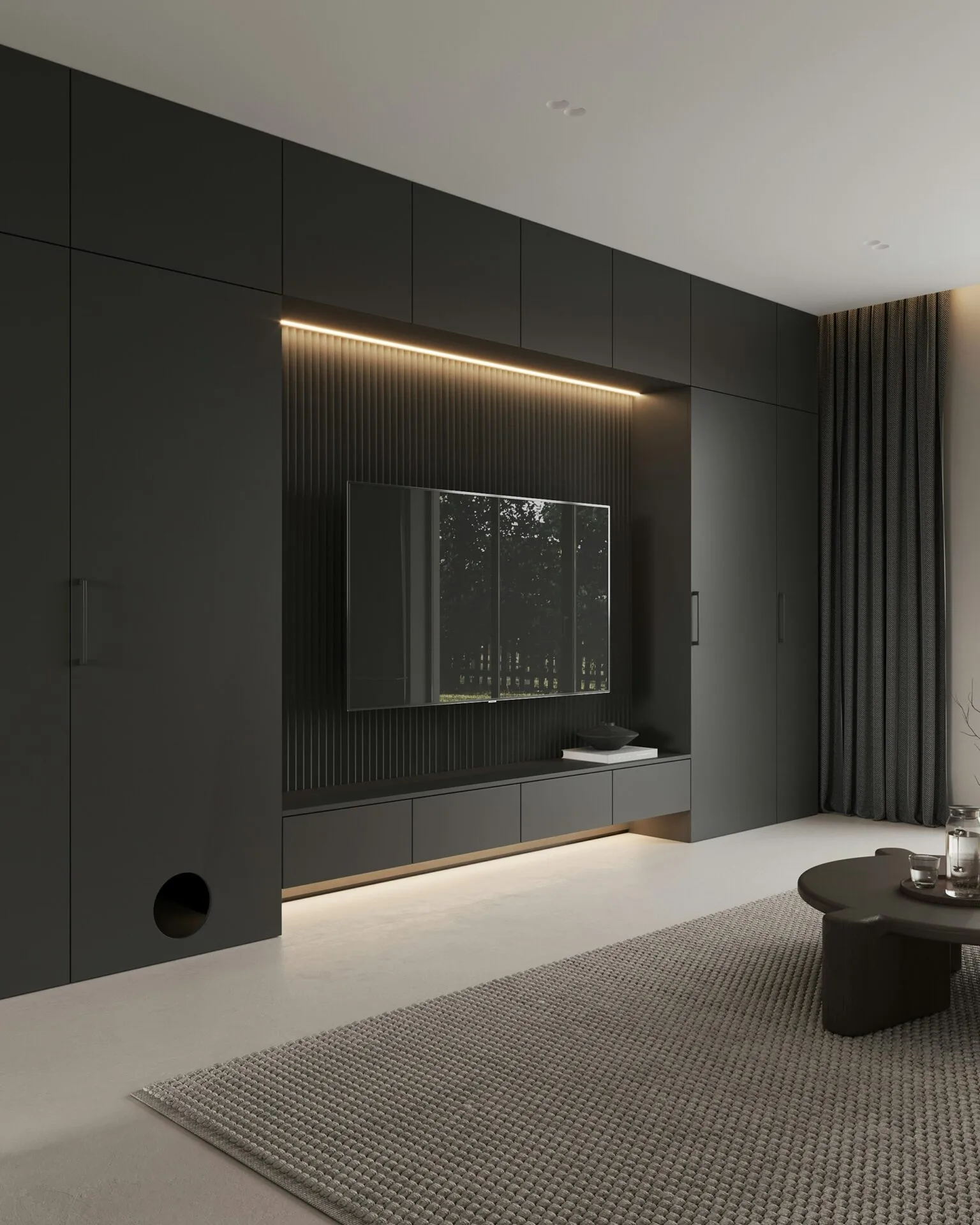 A modern bedroom setting with dark furniture, modern lighting and a large wall-mounted television 