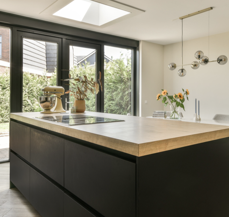 A bright, modern kitchen and countertop with assorted furniture